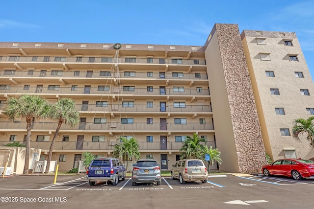 3170 N Atlantic Ave N Unit 403, Cocoa Beach, FL 32931 - view of apartment building / complex with uncovered parking