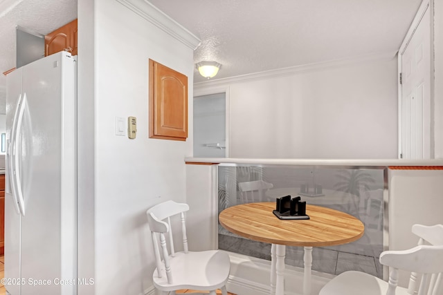 3170 N Atlantic Ave N Unit 403, Cocoa Beach, FL 32931 - dining room featuring crown molding and a textured ceiling