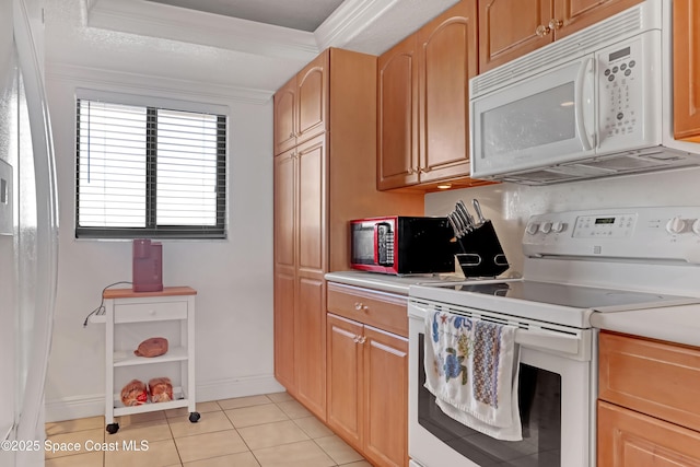 3170 N Atlantic Ave N Unit 403, Cocoa Beach, FL 32931 - kitchen featuring white appliances, light countertops, ornamental molding, and light tile patterned flooring