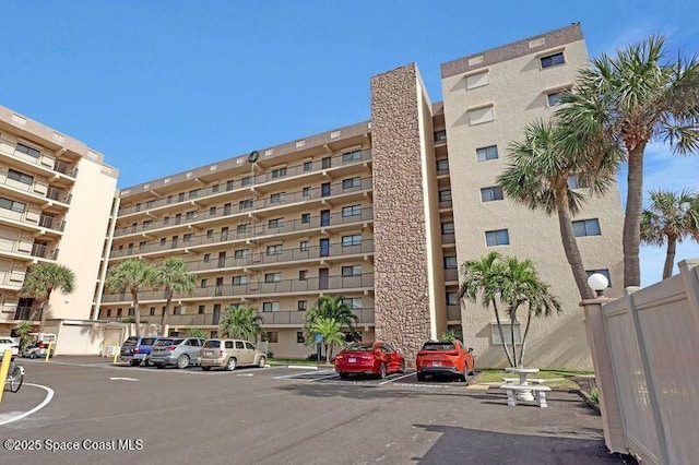 3170 N Atlantic Ave N Unit 403, Cocoa Beach, FL 32931 - view of apartment building / complex featuring uncovered parking