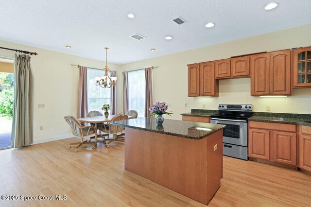 3825 Allen Ave, Micco, FL 32976 - kitchen with stainless steel electric range, a kitchen island, a chandelier, plenty of natural light, and recessed lighting