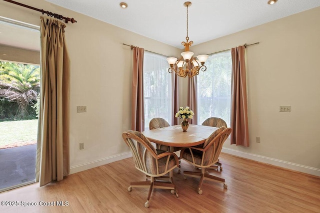 3825 Allen Ave, Micco, FL 32976 - dining space with a chandelier, light wood-style floors, and plenty of natural light