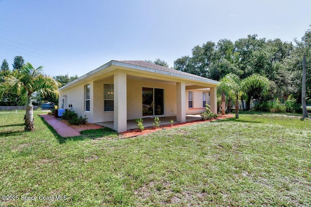 3825 Allen Ave, Micco, FL 32976 - back of house with stucco siding, a patio, and a yard