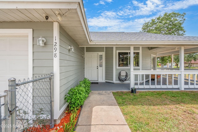 1298 Corning Ave NW, Palm Bay, FL 32907 - property entrance featuring a shingled roof, an attached garage, and covered porch