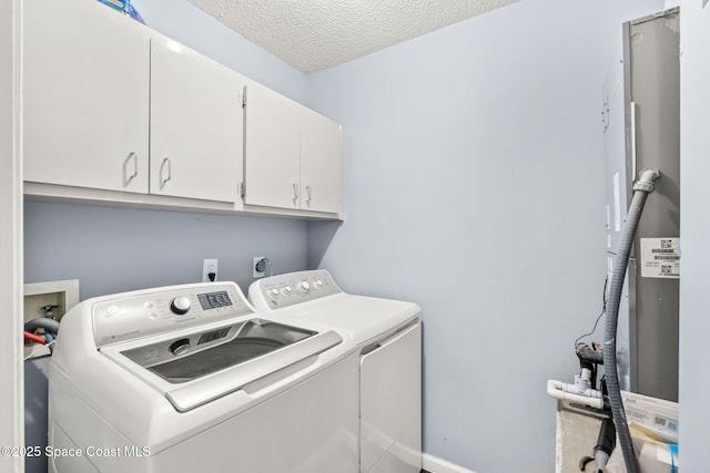 1298 Corning Ave NW, Palm Bay, FL 32907 - laundry room featuring washing machine and clothes dryer, cabinet space, and a textured ceiling