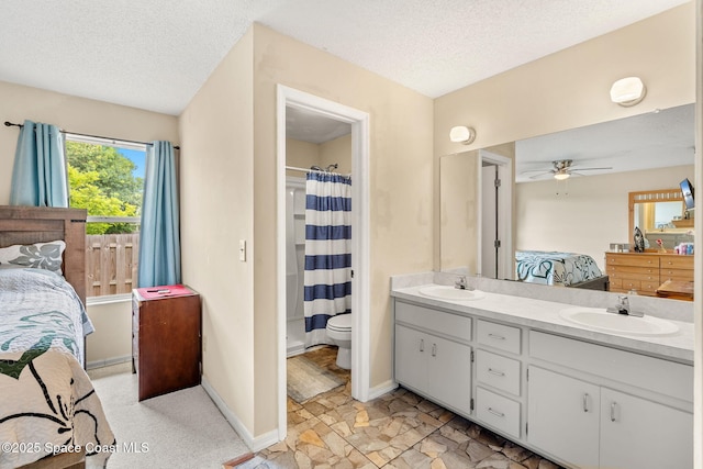 1298 Corning Ave NW, Palm Bay, FL 32907 - ensuite bathroom with double vanity, ceiling fan, a textured ceiling, and curtained shower