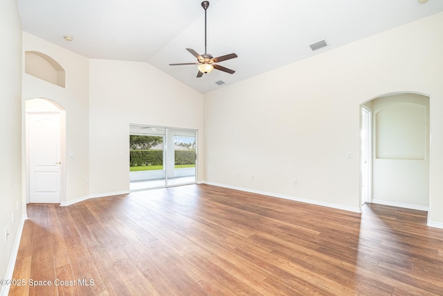 1713 Keys Gate Dr, Melbourne, FL 32940 - empty room featuring a ceiling fan, high vaulted ceiling, light wood-style flooring, and arched walkways