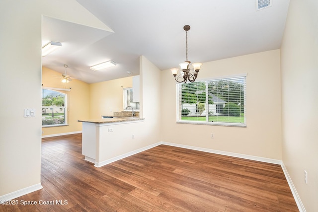 1713 Keys Gate Dr, Melbourne, FL 32940 - kitchen with wood finished floors, lofted ceiling, a chandelier, a ceiling fan, and a peninsula