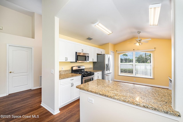 1713 Keys Gate Dr, Melbourne, FL 32940 - kitchen with stainless steel appliances, dark wood-style floors, lofted ceiling, ceiling fan, and white cabinets