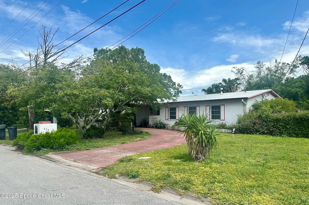 979 Bouganvillea Dr, Rockledge, FL 32955 - ranch-style home featuring a front lawn and stucco siding