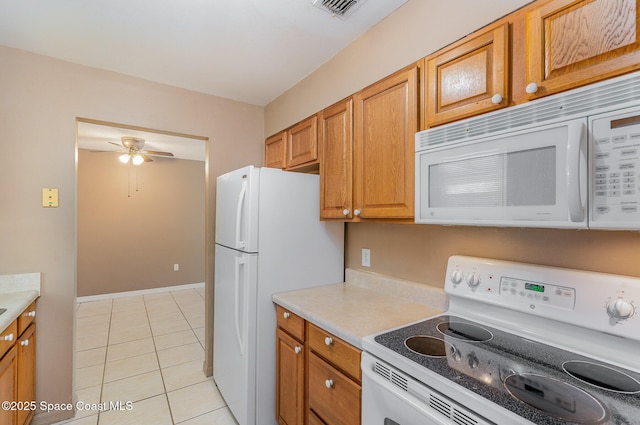 2234 Flower Tree Cir, Melbourne, FL 32935 - kitchen featuring white appliances, light tile patterned floors, ceiling fan, and light countertops