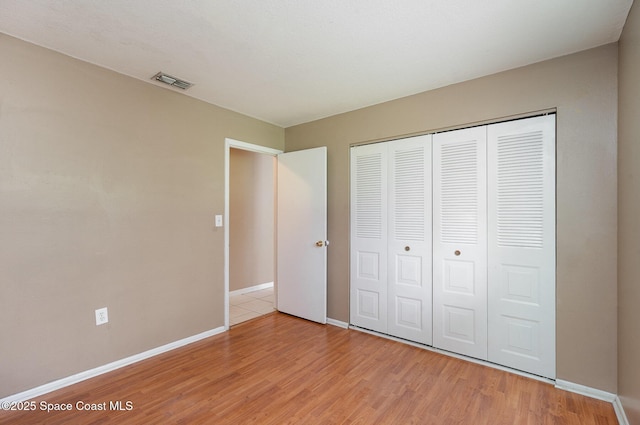 2234 Flower Tree Cir, Melbourne, FL 32935 - unfurnished bedroom with light wood-type flooring and a closet