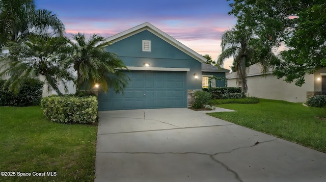 1448 Attilburgh Blvd, West Melbourne, FL 32904 - ranch-style home with stucco siding, an attached garage, a front yard, concrete driveway, and stone siding