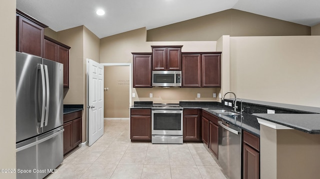 1448 Attilburgh Blvd, West Melbourne, FL 32904 - kitchen with stainless steel appliances, dark countertops, a peninsula, vaulted ceiling, and light tile patterned floors