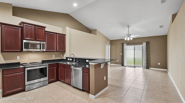 1448 Attilburgh Blvd, West Melbourne, FL 32904 - kitchen with appliances with stainless steel finishes, vaulted ceiling, a peninsula, light tile patterned floors, and a ceiling fan
