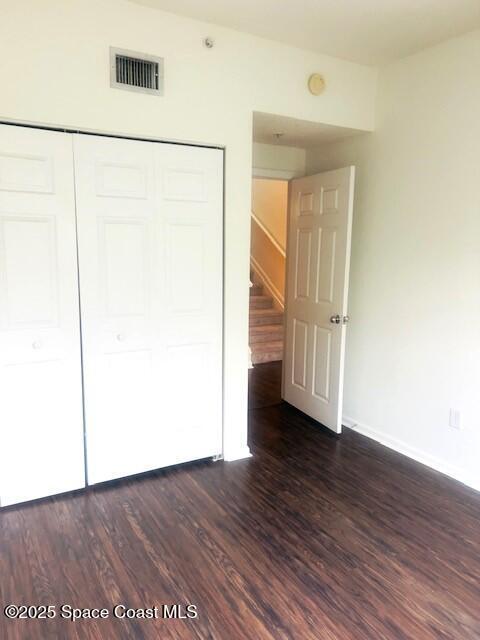 1070 Bella Vista Blvd Unit 110, Saint Augustine, FL 32084 - unfurnished bedroom featuring a closet and dark wood-style flooring
