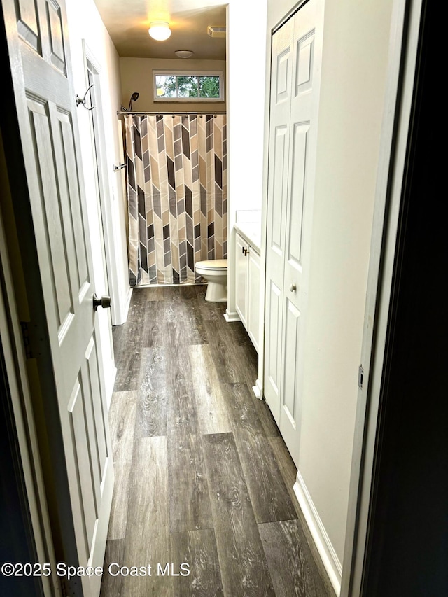 1070 Bella Vista Blvd Unit 110, Saint Augustine, FL 32084 - full bath featuring wood finished floors, a shower with shower curtain, and a closet