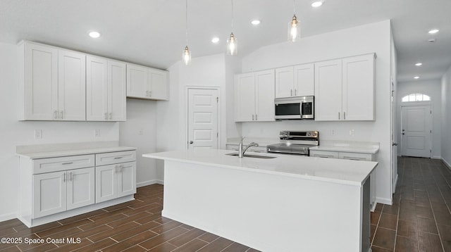 298 Trilby Rd SW, Palm Bay, FL 32908 - kitchen featuring appliances with stainless steel finishes, wood tiled floors, white cabinetry, recessed lighting, and vaulted ceiling