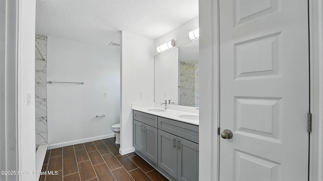 298 Trilby Rd SW, Palm Bay, FL 32908 - full bath featuring double vanity, a textured ceiling, a marble finish shower, and wood tiled floors