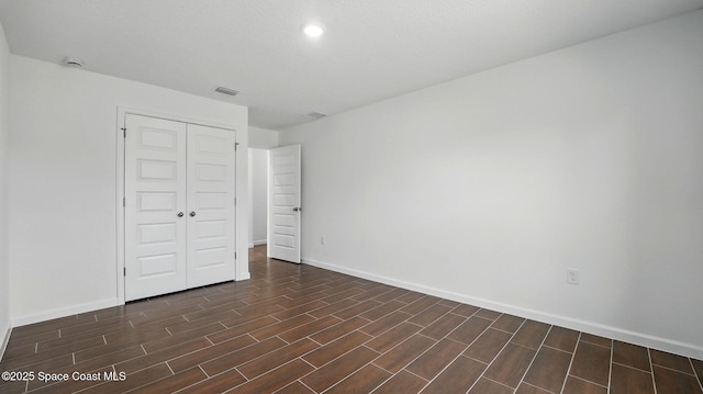298 Trilby Rd SW, Palm Bay, FL 32908 - unfurnished bedroom featuring a closet, dark wood-style floors, and recessed lighting