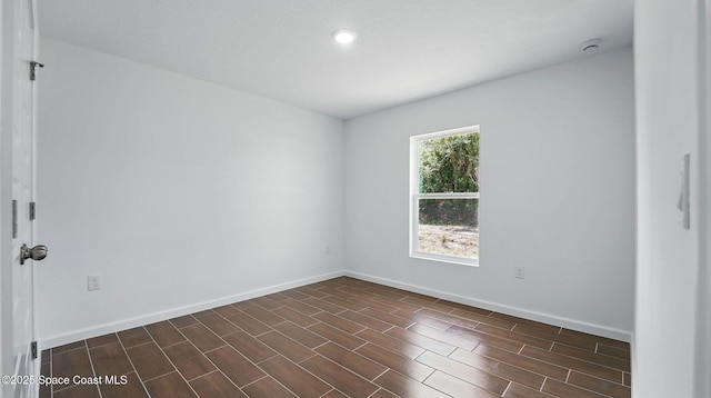 298 Trilby Rd SW, Palm Bay, FL 32908 - unfurnished room with a smoke detector, dark wood-type flooring, and recessed lighting