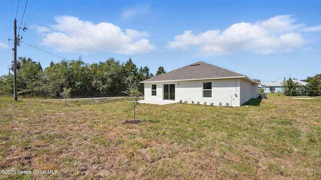 298 Wendover Rd SW, Palm Bay, FL 32908 - back of house with stucco siding and a lawn