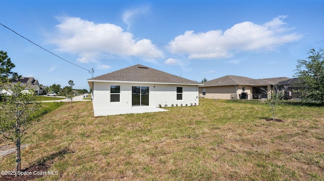 298 Wendover Rd SW, Palm Bay, FL 32908 - back of property with stucco siding, a yard, and a patio area