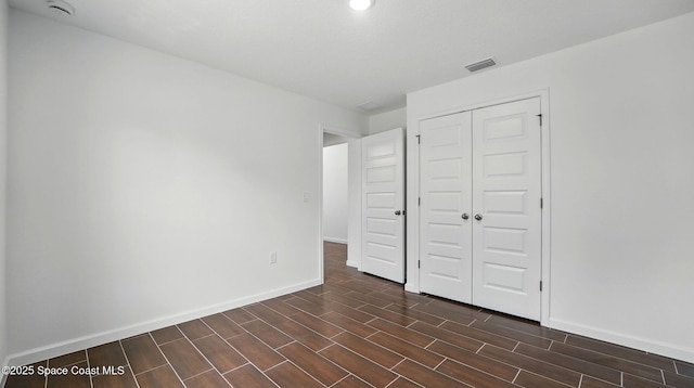 298 Wendover Rd SW, Palm Bay, FL 32908 - unfurnished bedroom featuring a closet, wood tiled floors, and recessed lighting