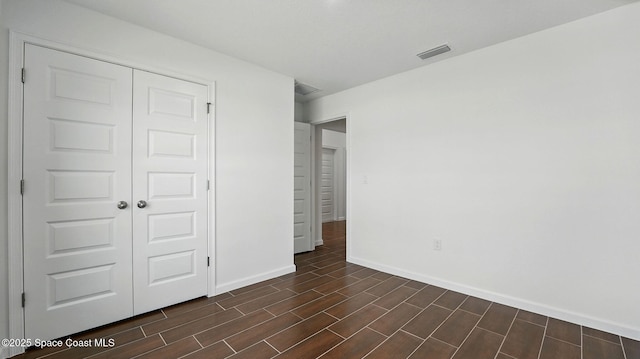 298 Wendover Rd SW, Palm Bay, FL 32908 - unfurnished bedroom featuring a closet and wood tiled floors