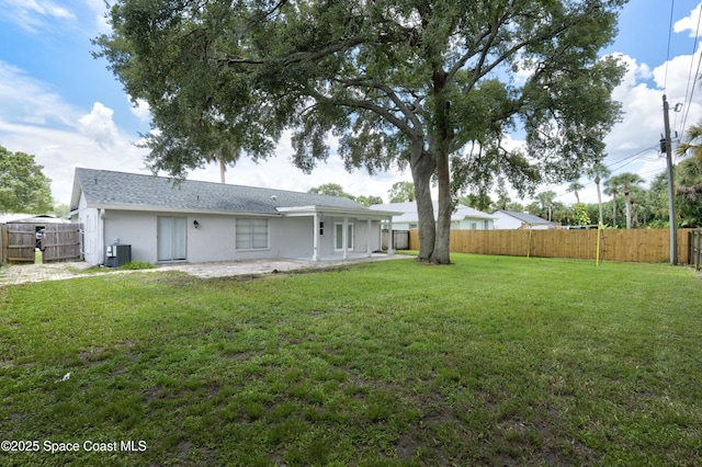 1249 Coosa Ave NE, Palm Bay, FL 32907 - fenced backyard featuring a patio