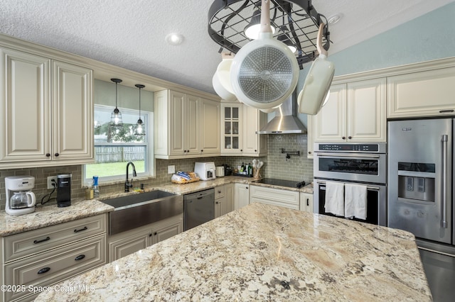 1249 Coosa Ave NE, Palm Bay, FL 32907 - kitchen with stainless steel appliances, cream cabinetry, light stone counters, backsplash, and a textured ceiling