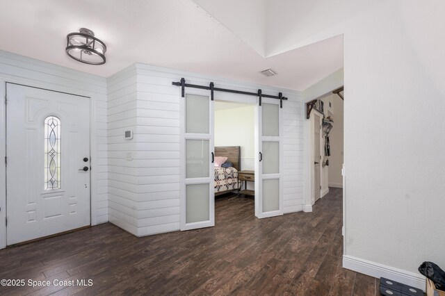 1249 Coosa Ave NE, Palm Bay, FL 32907 - foyer featuring a barn door and wood finished floors