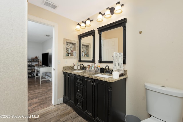 1249 Coosa Ave NE, Palm Bay, FL 32907 - bathroom featuring wood finished floors and double vanity