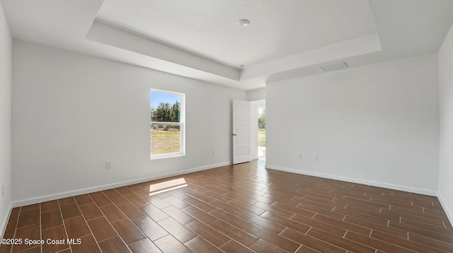 1343 Danforth St SW, Palm Bay, FL 32908 - spare room featuring a tray ceiling and wood tiled floors