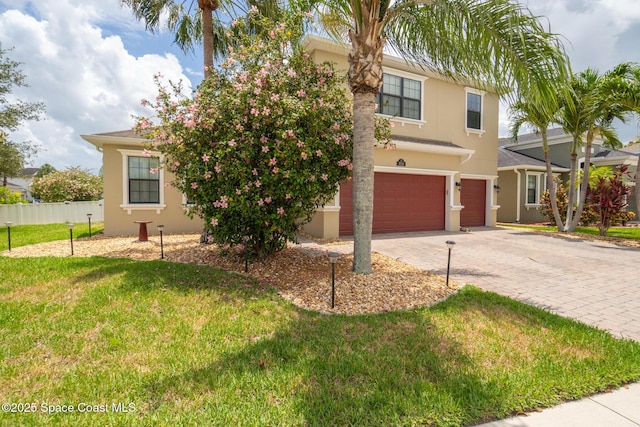 1026 Shiloh Dr, Melbourne, FL 32940 - view of front of property featuring a garage, stucco siding, and driveway