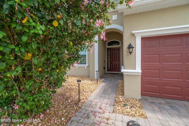1026 Shiloh Dr, Melbourne, FL 32940 - doorway to property featuring stucco siding and an attached garage