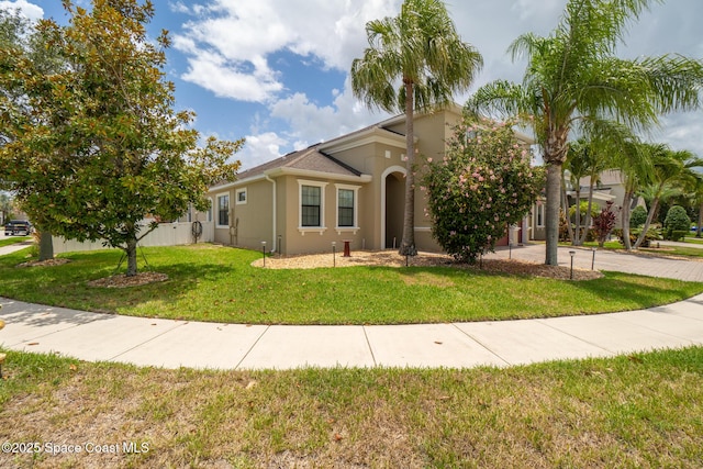 1026 Shiloh Dr, Melbourne, FL 32940 - mediterranean / spanish house with stucco siding and a front lawn
