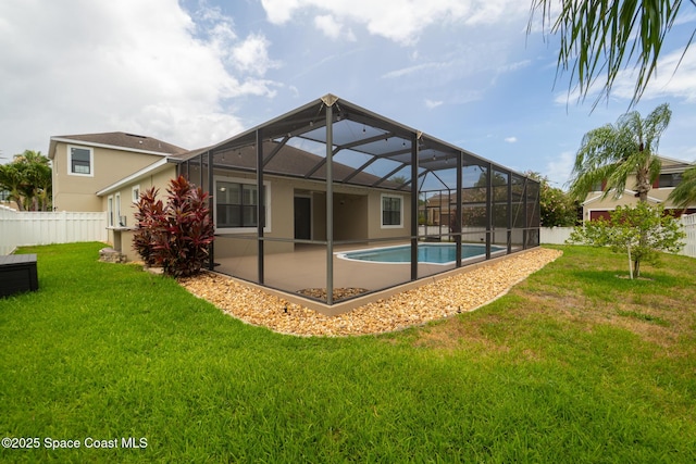 1026 Shiloh Dr, Melbourne, FL 32940 - rear view of house with a fenced backyard, stucco siding, and glass enclosure