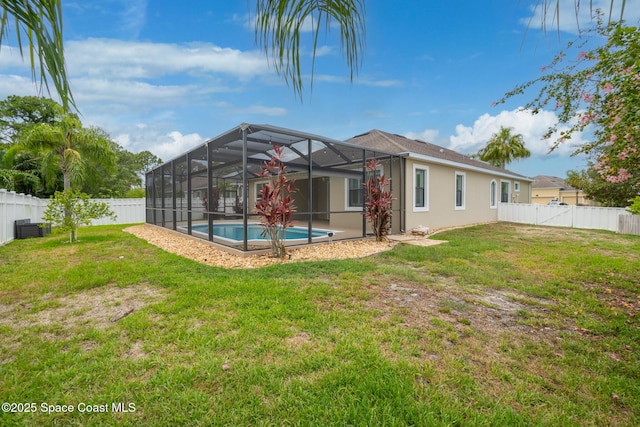 1026 Shiloh Dr, Melbourne, FL 32940 - rear view of property featuring a fenced backyard, glass enclosure, and stucco siding