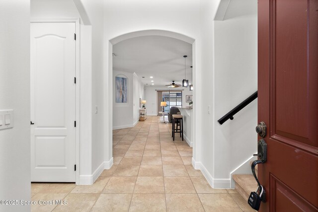 1026 Shiloh Dr, Melbourne, FL 32940 - entrance foyer with arched walkways, ceiling fan, light tile patterned floors, and recessed lighting
