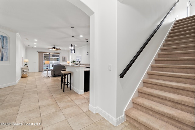 1026 Shiloh Dr, Melbourne, FL 32940 - stairs with tile patterned floors, recessed lighting, a ceiling fan, arched walkways, and ornamental molding