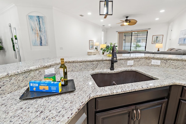 1026 Shiloh Dr, Melbourne, FL 32940 - kitchen with open floor plan, dark brown cabinets, recessed lighting, a ceiling fan, and light stone countertops
