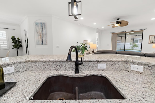 1026 Shiloh Dr, Melbourne, FL 32940 - kitchen featuring open floor plan, light stone countertops, crown molding, ceiling fan, and recessed lighting
