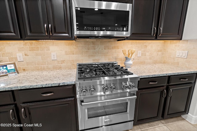 1026 Shiloh Dr, Melbourne, FL 32940 - kitchen featuring stainless steel appliances, light stone counters, and decorative backsplash