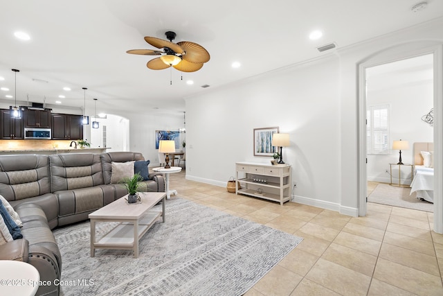 1026 Shiloh Dr, Melbourne, FL 32940 - living room featuring light tile patterned flooring, recessed lighting, a ceiling fan, a chandelier, and crown molding