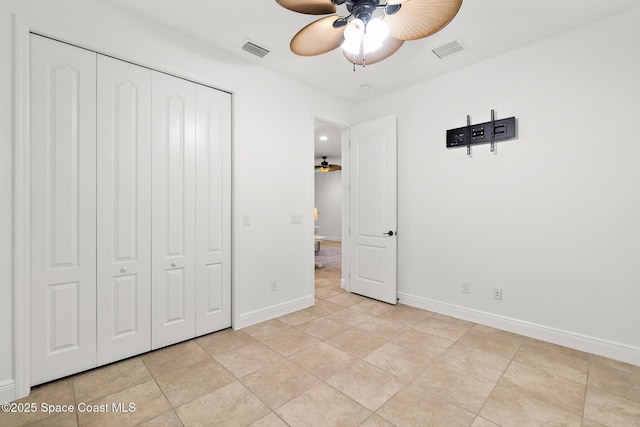 1026 Shiloh Dr, Melbourne, FL 32940 - unfurnished bedroom featuring a closet, a ceiling fan, and light tile patterned floors