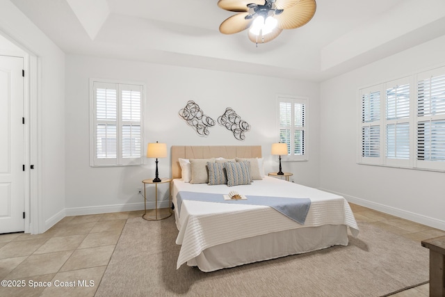 1026 Shiloh Dr, Melbourne, FL 32940 - bedroom featuring a raised ceiling, light tile patterned floors, and a ceiling fan