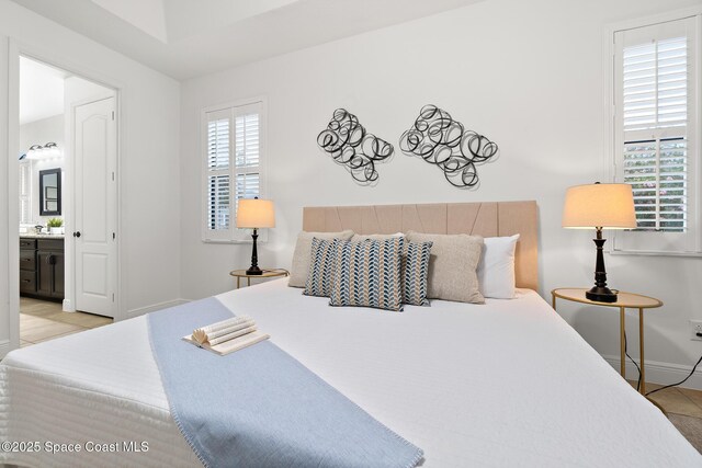 1026 Shiloh Dr, Melbourne, FL 32940 - bedroom with light tile patterned floors and ensuite bathroom