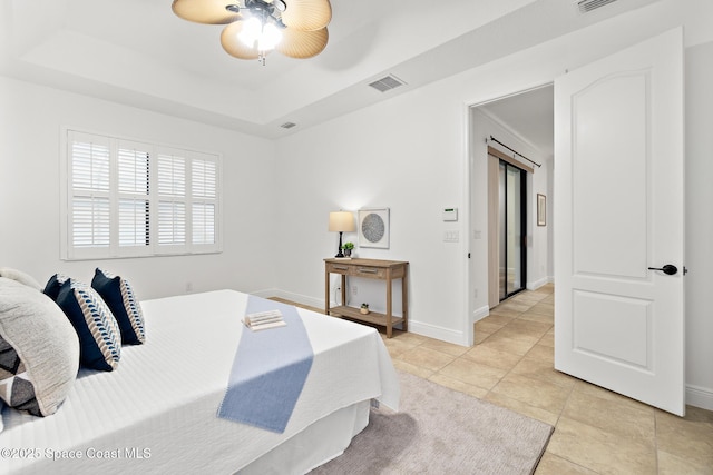 1026 Shiloh Dr, Melbourne, FL 32940 - bedroom with a tray ceiling, light tile patterned floors, and a ceiling fan