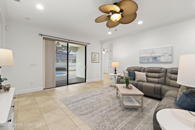 1026 Shiloh Dr, Melbourne, FL 32940 - living area featuring a ceiling fan, light tile patterned flooring, arched walkways, crown molding, and recessed lighting